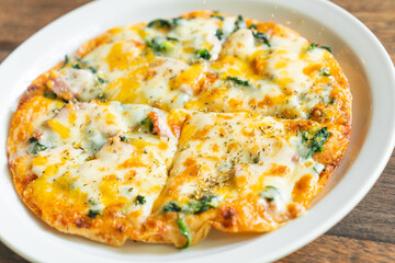 spinach and bacon pizza on plate