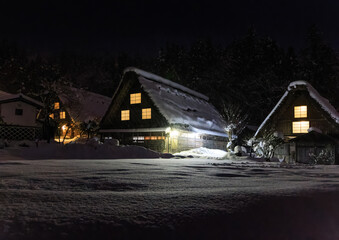 Lights from traditional thatched roof houses in Shirakawa-go at night