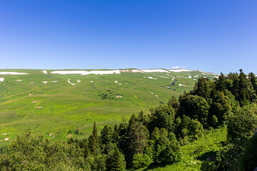 Summer, mountainous terrain, hiking trails running through the park, a place for walking and recreation.