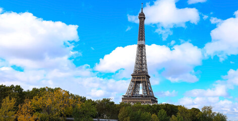 The Eiffel Tower, iconic Paris landmark  as autumn trees park  as Seine river with blue sky scene in Paris ,France