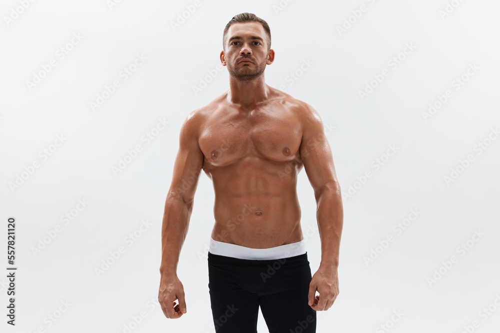 Wall mural man athletic body bodybuilder in briefs with naked torso abs full-length in the background, fitness 