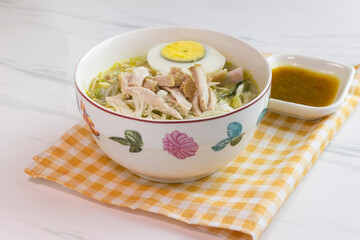 Chicken Soto with chili sauce or Soto Ayam in Indonesia. Soto ayam is a traditional Indonesian food