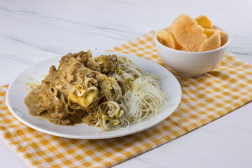 ketoprak or Tofu rhombus served with vermicelli watered with peanut seasoning and bowl of crackers