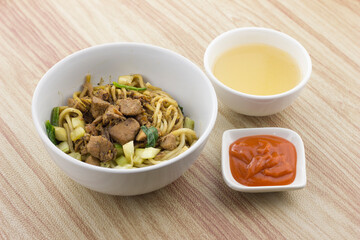 Indonesian food, Mie Ayam or Bakmie ayam, seasoned yellow wheat noodles topped with diced chicken meat