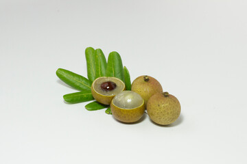 selective focus of fresh Longan tropical fruit and green leaf on white background