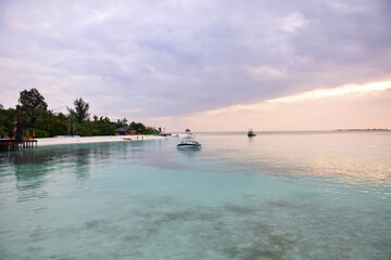 Fototapeta na wymiar Beautiful Tropical sunset landscape in Maldives island Baa , with infinity Indian ocean sea water view and cloudy skies , perfect Honeymoon travel destination 