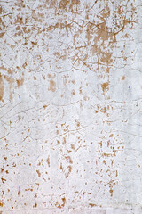 old cracked plaster wall painted in white