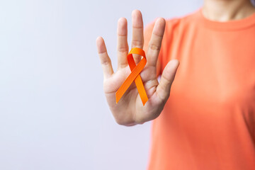 Orange Ribbon for Leukemia, Kidney cancer day, world Multiple Sclerosis, CRPS, Self Injury Awareness month. Healthcare and word cancer day concept - obrazy, fototapety, plakaty