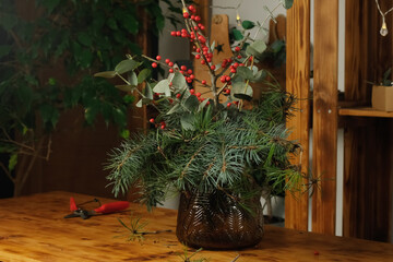 Winter bouquet in vase for home interior decoration. Christmas flower arrangement
