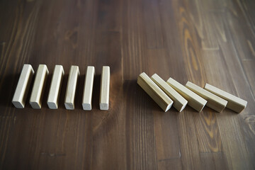 Closeup thick domino wood block in a row stop the falling, be stable in crisis, business solution concept