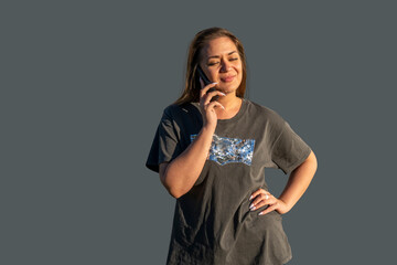 Young woman with a telephone - talking, writes a message, looks into the smartphone
