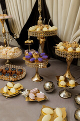Table with cakes, sweets, candy, buffet. Dessert table for a party goodies for the wedding banquet area. Close up candy bar. Decorated delicious.