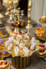 Table with cakes, sweets, candy, buffet. Dessert table for a party goodies for the wedding banquet area. Close up candy bar. Decorated delicious.