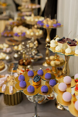Table with cakes, sweets, candy, buffet. Dessert table for a party goodies for the wedding banquet area. Close up candy bar. Decorated delicious.