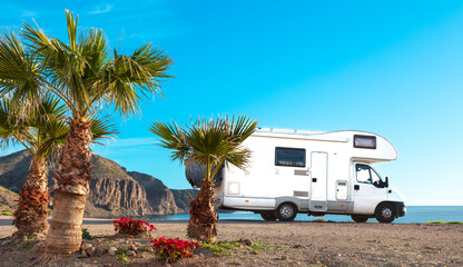 Family travel,  holiday road trip in motorhome ( sea, palm tree, beach) Andalusia in Spain - obrazy, fototapety, plakaty