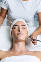 Beautiful woman getting oxygen face therapy in a beauty salon. Professional skin care treatment.