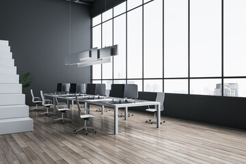 Side view on big light table with modern computers in spacious coworking office with wooden floor, white stairway and city view background from panoramic window. 3D rendering