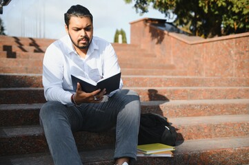 Happy indian male student at the university.