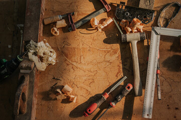 Wooden table with professional tools and saw dust