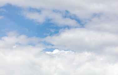 White clouds on the blue sky as a background.