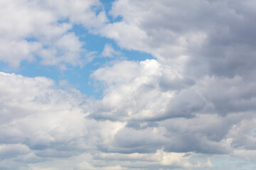 White clouds on the blue sky as a background.