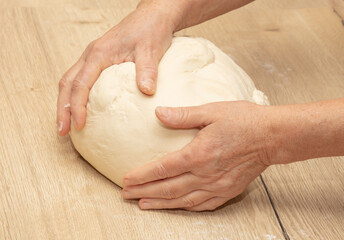 Hand kneading flour dough.