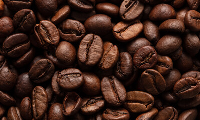 Grains of black coffee as a background.