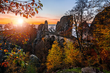 Saxon, Germany - Beautiful view of the Bastei bridge on a sunny autumn sunrise with colorful foliage. Bastei is famous for the beautiful rock formation in Saxon Switzerland National Park near Dresden