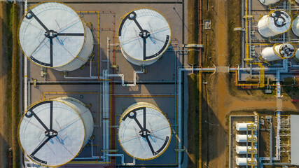Aerial view white oil storage fuel tanks at depot station, White Industrial tanks for gasoline petrol and oil fuel with pipeline, Oil and gas industrial, Oil refinery plant industry.