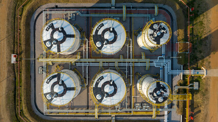 Aerial view white oil storage fuel tanks at depot station, White Industrial tanks for gasoline petrol and oil fuel with pipeline, Oil and gas industrial, Oil refinery plant industry.