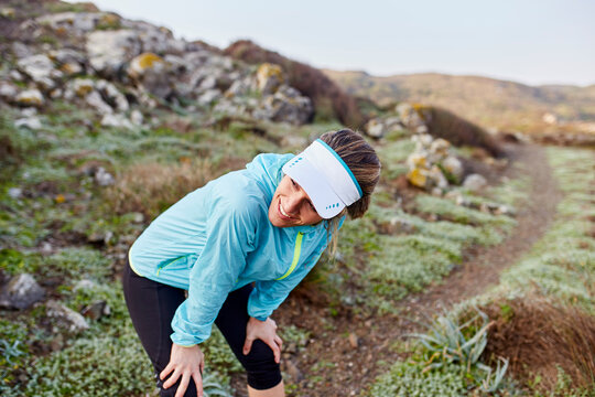 Happy trail runner taking break after run