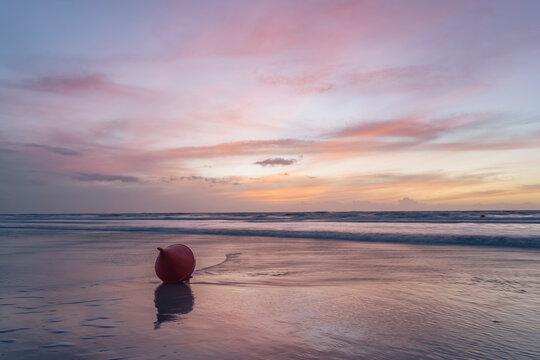 Germany, Schleswig-Holstein, St. Peter-Ording, Bouy lying on empty beach at dusk