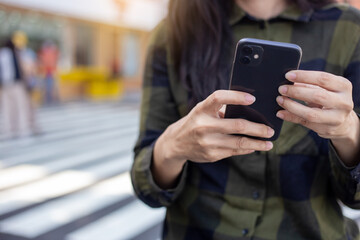 woman using cell phone hand holding mobile texting message contact us.chatting,search internet information.technology device communication connecting