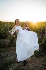 Wedding in the vineyards, bride and groom in the sunset