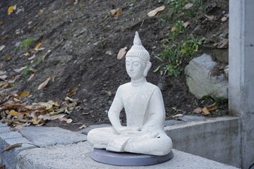 Little Buddha white statue in the garden 