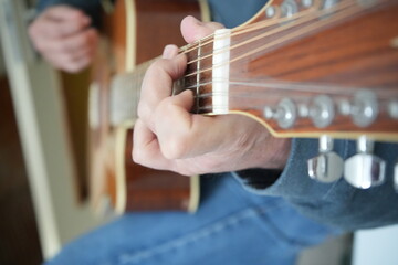 Fototapeta premium Man playing 12 strings acoustic guitar 
