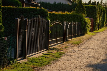 Fencing made of metal rods by the dirt road