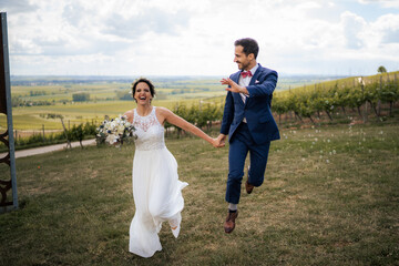 Fototapeta na wymiar Happy couple after wedding in the vineyards of Rheinhesse, Germany 