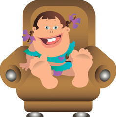 A little girl with pigtails sits in a chair and smiles.