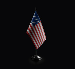 Small national flag of the USA on a black background