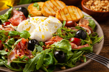 Salad with burrata cheese and croutons.