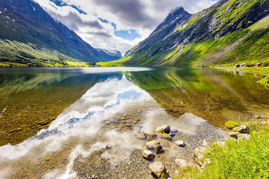 Smooth water reflects the mountains