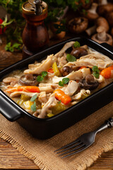 Chicken casserole. Served in black pots.