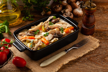 Chicken casserole. Served in black pots.