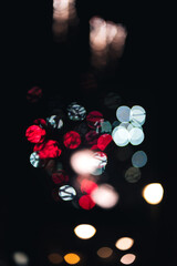 Nighttime bokeh effect of fireworks in the distance. Red, white and yellow.