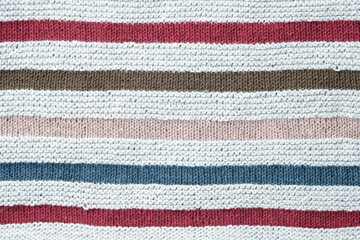 Knitted background. Texture of striped knitted cotton fabric close up.