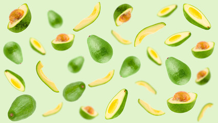 Falling avocado on pastel green surface for advertisement