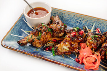Roasted chicken shins with pomegranate and herbs