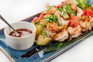 Dish of glass noodles with srimps and vegetables on grey background. Wok menu