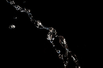 Fototapeta na wymiar Water splash on the black background
